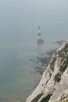 Beachy head lighthouse at the edge of white chalk cliff. Safety warning in the Stockfoto's