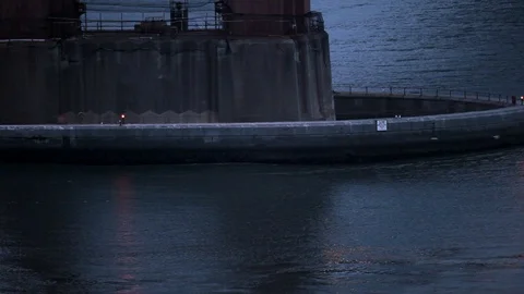 Beacon light flashing at the base of a bridge at night. Stock Footage 88342391