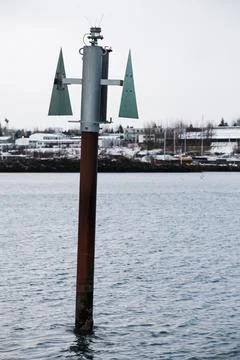 Beacon pole with green triangular top mark shape pointing up 스톡 사진