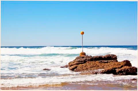 Beacon on shoreline Stock Photos
