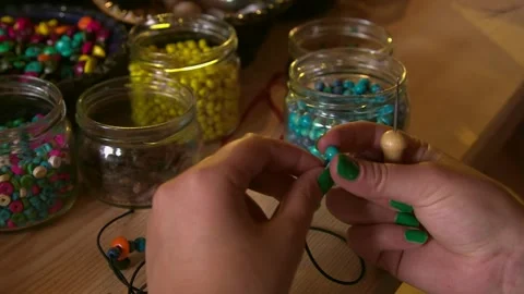 Bead workshop with a lot of different wooden and plastic beads as well as shells Stock Footage 248847083