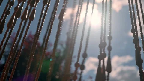 Beaded Curtain Silhouette With Sunlight Streaming Through Wooden Beads Vidéo 340632035