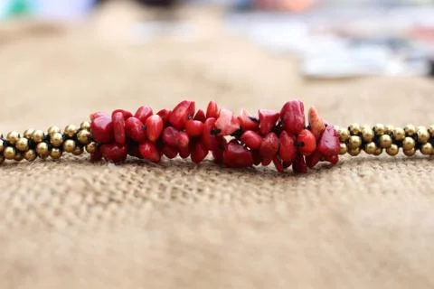 Beaded necklace on sackcloth background Stock Photos