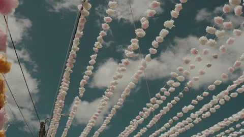 Beaded Paper Flower Strings Beside Streetlight at Portuguese Festival Video stock 340225316