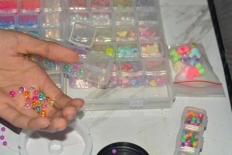 Beading workplace with hands in the process of handicraft. Beautiful diy je.. Stock Photos