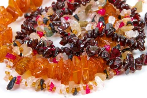 Beads of different stones on a white background Stock Photos