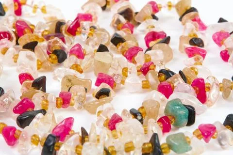 Beads of different stones on a white background Stock Photos