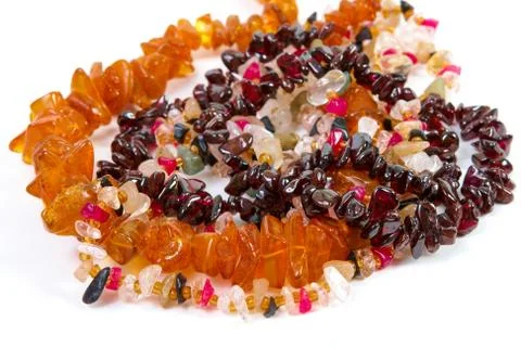 Beads of different stones on a white background Stock Photos