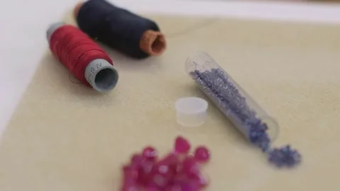 Beads, scissors and thread on workplace are ready for making jewelry accessories Stock Footage 73498403