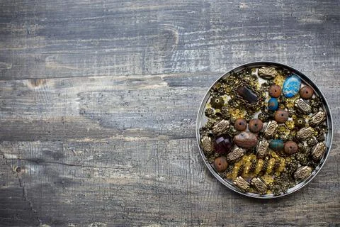Beads into tin lid Stock Photos
