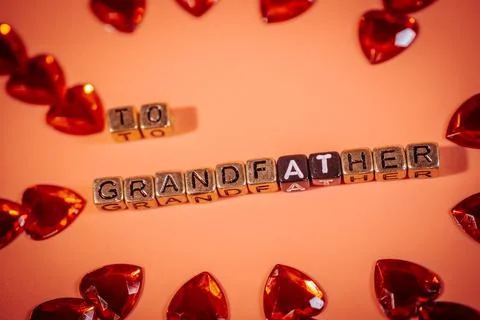 Beads on a warm background form the words &amp;quot;To Grandpa&amp;quot;. Фото