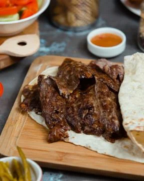 Beafsteak is served with lavash on the table Stock Photos