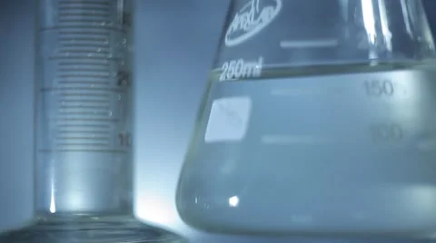 Beaker and Flask on a Glass Table. Close Up Stock Footage 54615138