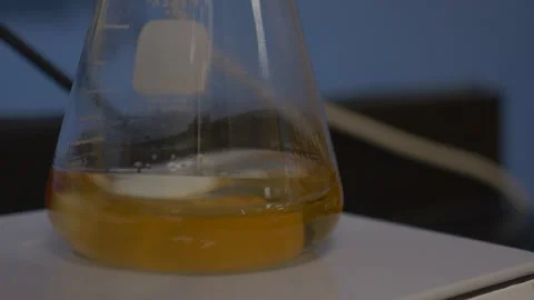 Beaker with liquid being spun Stock Footage 137282264