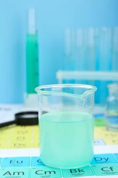 Beaker on periodic table of chemical elements, closeup Stock Photos