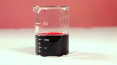 Beaker with red liquid on white background. Stock Footage 246956492