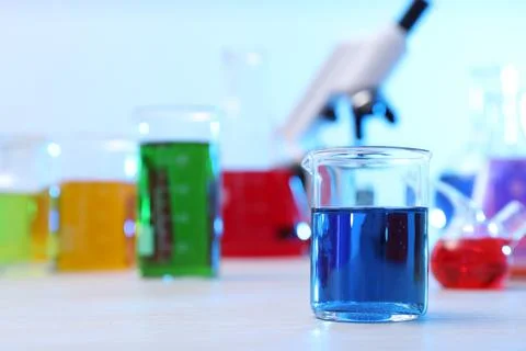 Beaker with sample on table in chemistry laboratory, space for text Stock Photos