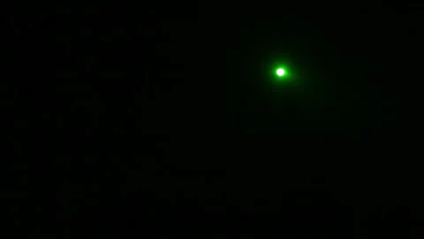 A beam of green light from a profile spotlight directed onto the stage in total Vídeo Stock 97136339