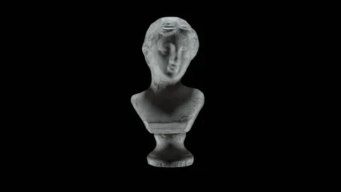 A beam of light in a circular motion illuminates the ancient head of the unknown Stock Footage 152640947