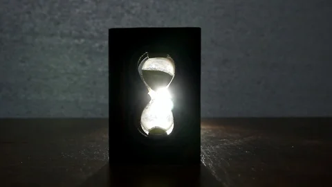 A beam of light passes through an hourglass Stock Footage 85493641