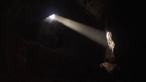 Beam of light peeping through an opening in the rocks Stock Footage 79786642