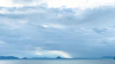 A beam of light through the cloudy blue sky after raining with mountain Stock Footage 153464321