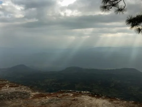 Beam or ray of light through cloud to forest on mountain view Stock Photos