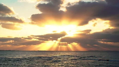 Beam sun light pass through cloud before sunset over the ocean Stock Footage 153590306