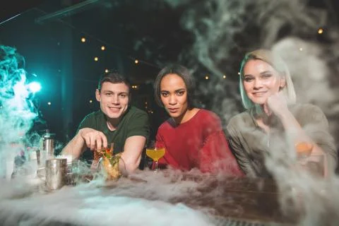 Beaming comrades having fun at pub counter Stock Photos