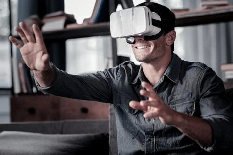 Beaming guy wearing vs headset and gesturing Stock Photos