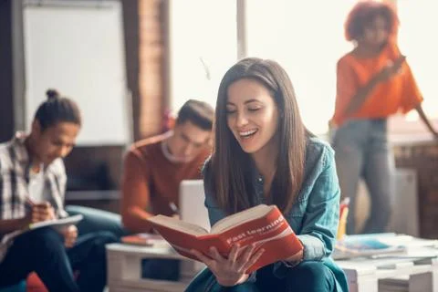 Beaming student feeling happy while studying foreign language Stock Photos