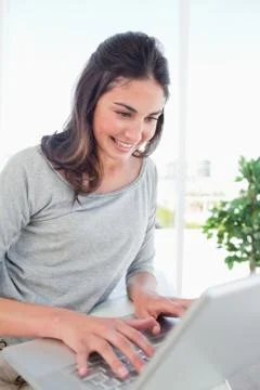 Beaming student using a personal computer Stock Photos
