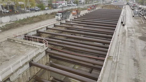 Beams cover metro construction pit in residential district Stock Footage 326471597