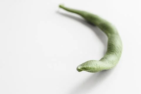 Bean pod close-up. Curved shape, with seeds inside. Space for text. Stock Photos