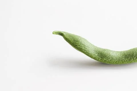 Bean pod close-up. Curved shape, with seeds inside. Space for text. Stock Photos