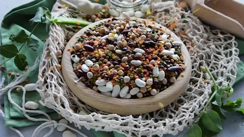 Beans and lentils pouring on table Stock Footage 135676749