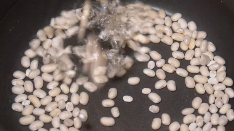 Beans are cooked in a pan, close-up Stock Footage 248049477