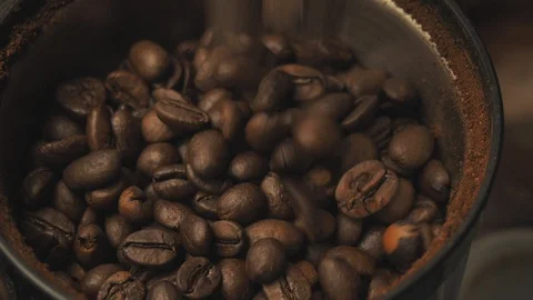 Beans are poured into the coffee grinder on top Stock Footage 129807563