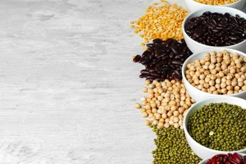 Beans assortment on white stone table, close up. Stock Photos