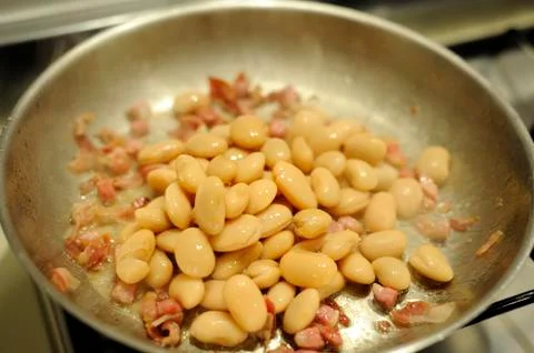 Beans baked with bacon Stock Photos