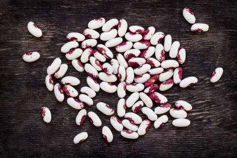 Beans (beans). Background from multi-colored beans. Wood texture Stock Photos