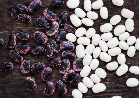 Beans (beans). Background from multi-colored beans. Wood texture Stock Photos