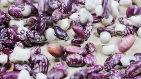 Beans cascading gracefully onto a rustic wooden table Stock Footage 292302608