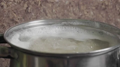 Beans Cooking Process White bean seeds in boiling water in a saucepan. Stockbeeldmateriaal 144992285