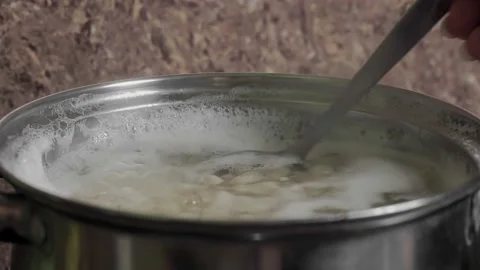 Beans Cooking Process White bean seeds in boiling water in a saucepan Vídeo Stock 145124985