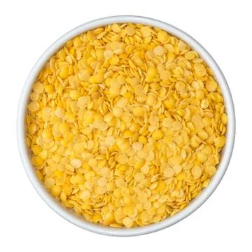 Beans of dry yellow split lentils in white bowl isolated on white background. Stock Photos