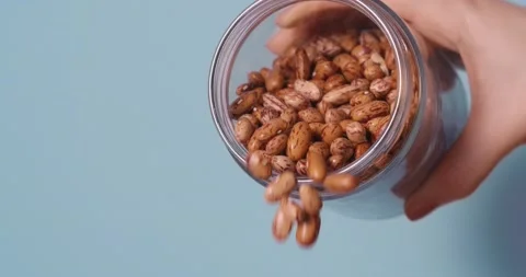 Beans falling from jar to cook healthy organic meal. Stock Footage 135233211
