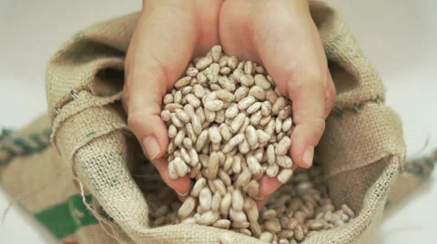 Beans Falling Through Fingers into Bag Stock Footage 37655377