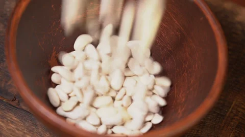 Beans poured into a bowl Stock Footage 249731319