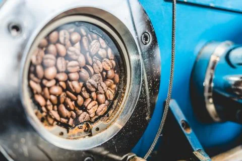 Beans in small window of coffee roaster Stock-Fotos